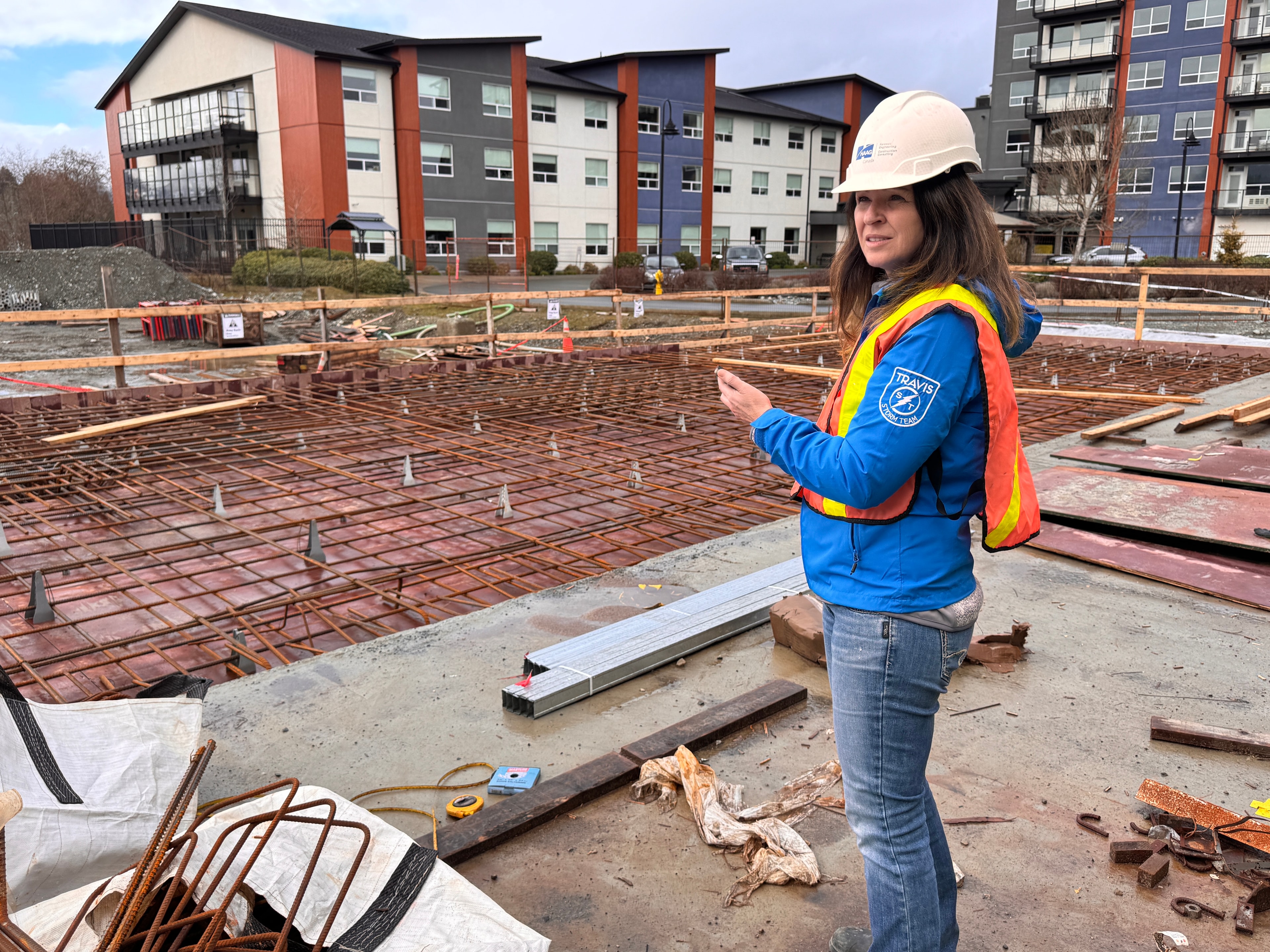 Paige Foster on a construction site with rebar foundation in the foreground